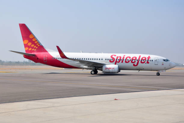 SpiceJet Boeing 737 HYDERABAD, INDIA - DECEMBER 24, 2014: A SpiceJet Boeing 737 on the tarmac at Rajiv Gandhi International Airport. SpiceJet is an Indian low-cost airline owned by the Sun Group of India. hyderabad india photos stock pictures, royalty-free photos & images