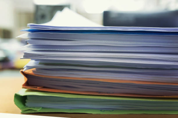 istock Pile of unfinished a bundle documents on office desk. 825419784
