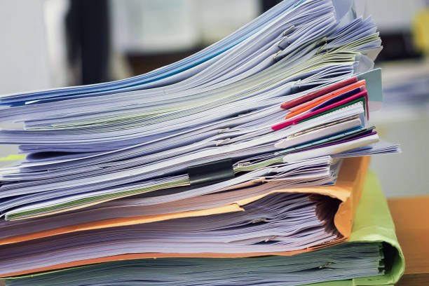 istock Pile of unfinished a bundle documents on office desk. 825419910