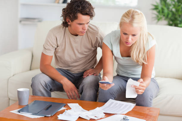 istock Shocked couple calculating their expenses 825420000