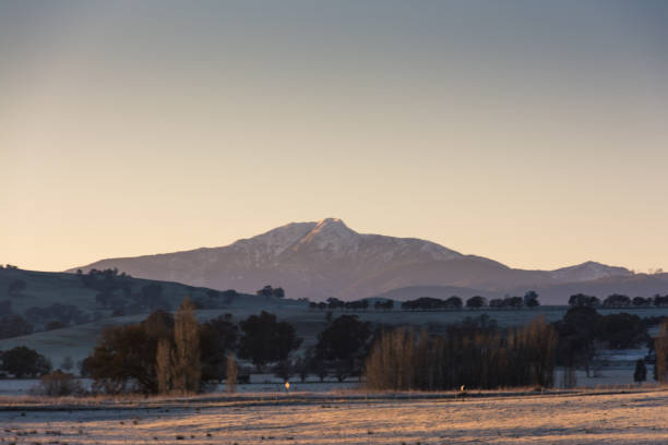 istock Morning sunrise glow over snow covered mountains 825424040
