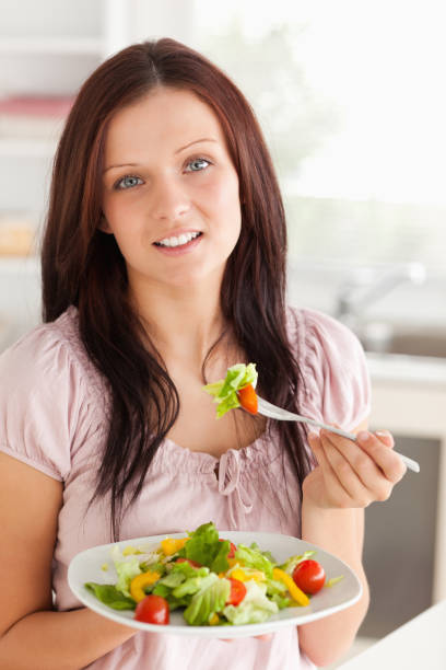 istock Woman with salad looking into camera 825424956