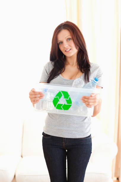 istock Woman showing recycling bin 825425062