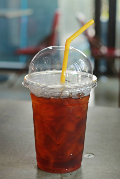 istock Plastic glass of cold iced black tea. 825428644