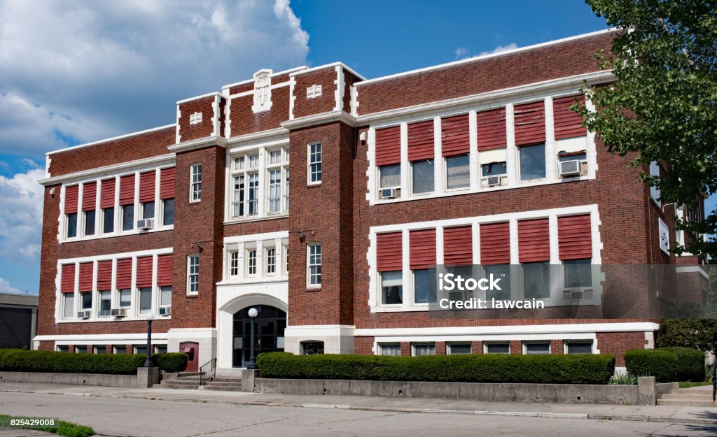 Old Catholic School Building Stately, old, red brick school building built in the 1930`s. School Building Stock Photo