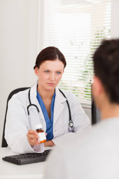 istock Female doctor giving patient pills 825431972