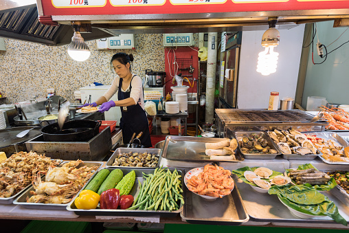 Taipei, Taiwan - April 6, 2017: Food stall at the The Shilin Night Market in Taipei, Taiwan. Shilin  Night Market is a night market in the Shilin District of Taipei, Taiwan, and is often considered to be the largest and most famous night market in the city.