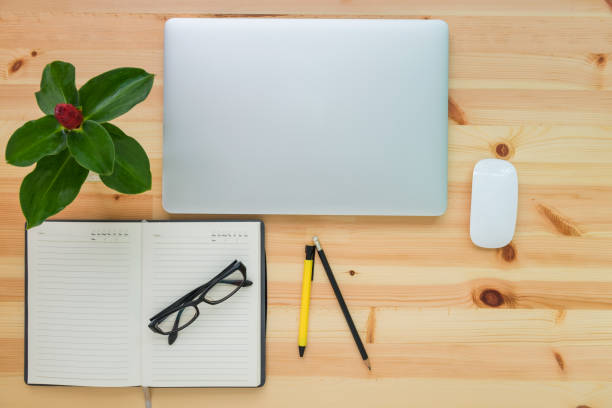 istock Business equipment concept on table top view with wooden background 825436484