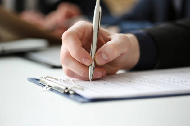 istock Hand of businessman signing document with pen 825439880