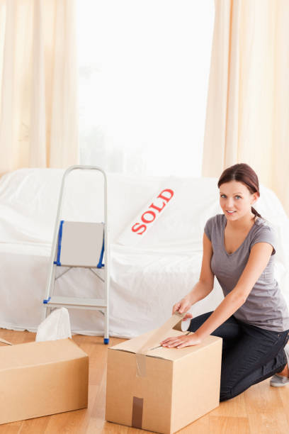istock Woman preparing cardboards for transport 825443196