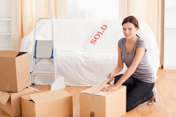 istock Female preparing cardboard box for transport 825443324