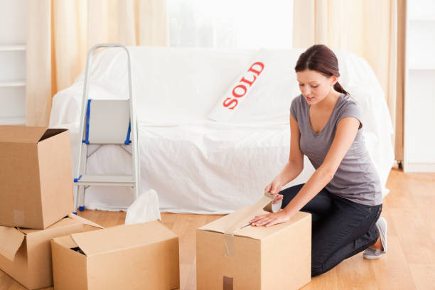 istock Female preparing cardboards for transport 825443574