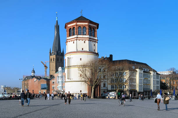 Dusseldorf, Germany - March 15, 2012: Schlossturm and St. Lambertus Basilica in sunny spring day. Schlossturm is the extant tower of Dusseldorf castle. Today it uses as a Maritime Museum. The basilica was built in 1288 and now this is the oldest surviving building in Dusseldorf.