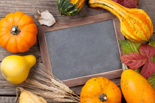 istock Autumn pumpkins on wooden table 825457266
