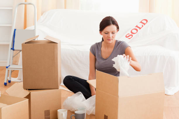 istock Gorgeous woman packing her property 825457884