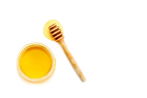 istock Bank with fresh honey on a white background 825457968