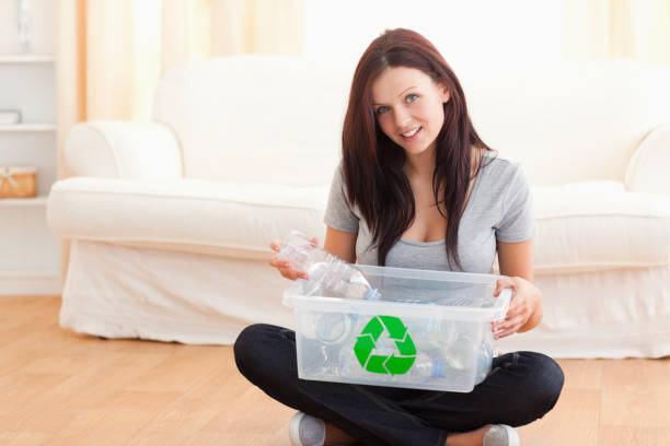 istock Cute woman with a recycling box 825458038