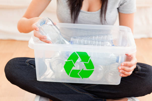istock Woman with a recycling box 825458248