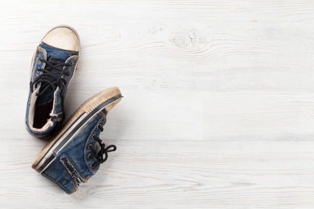 Free Stock Photo of Pair of worn sneakers on wooden floor | Download ...