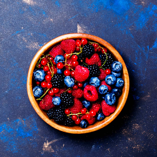 istock Summer fresh berries in assortment, fruit background, top view 825458738