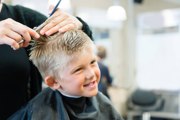 5 Year Old Getting A Haircut 5 Year Old Getting A Haircut at the barber shop. cutting hair stock pictures, royalty-free photos & images