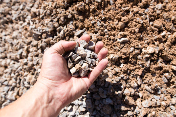 istock Building crushed stone with sand in hand 825464698