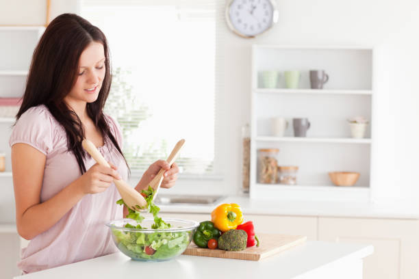 istock Redhaired woman preparing a salad 825467632