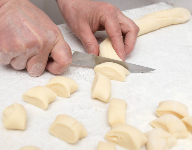istock Cook cooks dough for pieces 825469950