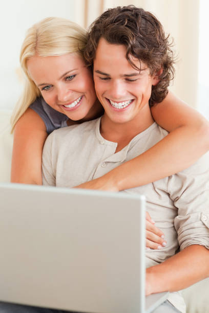 istock Portrait of a happy couple using a notebook 825486034