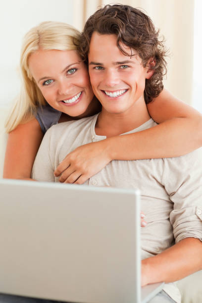 istock Portrait of a happy couple with a notebook 825486090