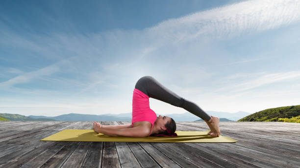 istock Young beautiful woman practicing outdoors yoga 825486132