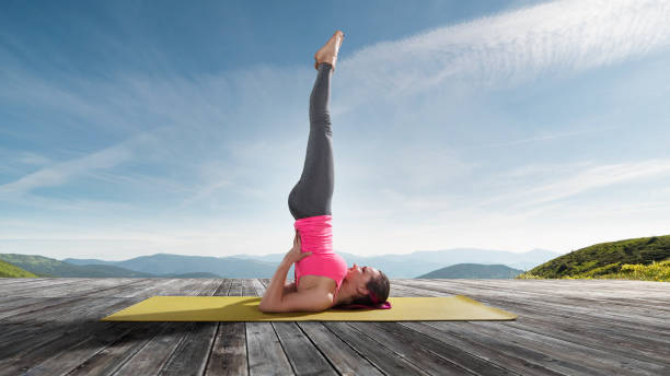 istock Young beautiful woman practicing outdoors yoga 825486172