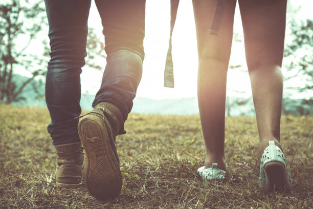 istock Men's legs with women walking together on vacation. 825486258