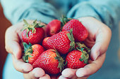holding fresh strawberry