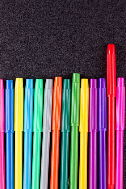 istock Color pencils on black background 825509382