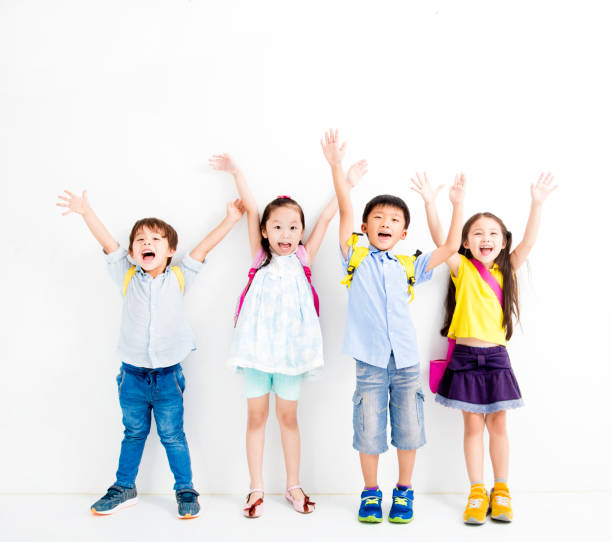 istock Group of happy smiling kids raise hands 825509944