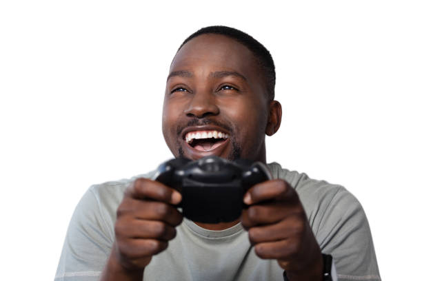 istock Smiling man playing video game against white background 825510386
