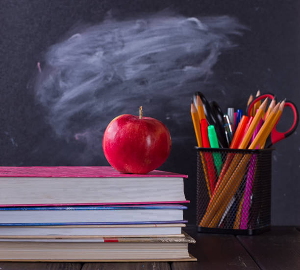 istock School books with apple on desk 825513138