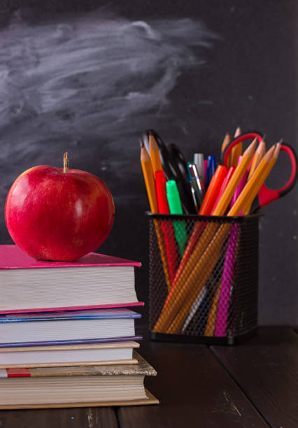 istock School books with apple on desk 825513192