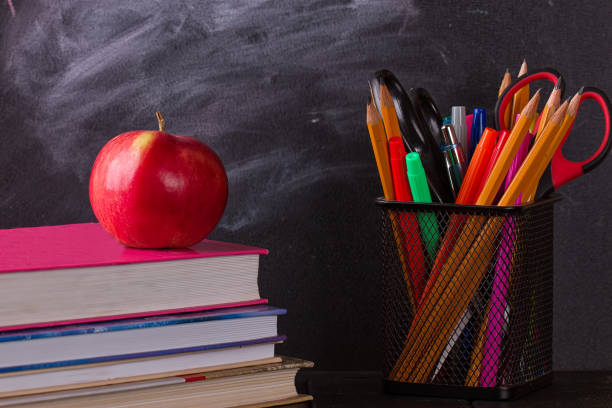 istock School books with apple on desk 825513264