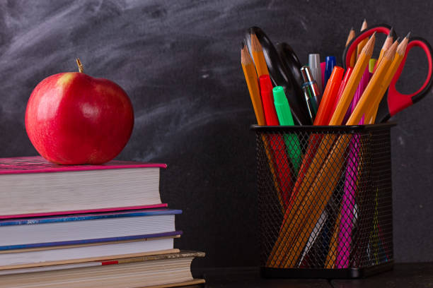 istock School books with apple on desk 825513306