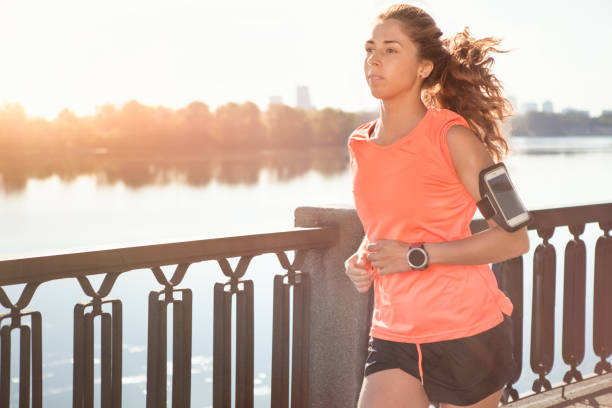 istock Runner is jogging in sunny bright light on sunrise. 825513318