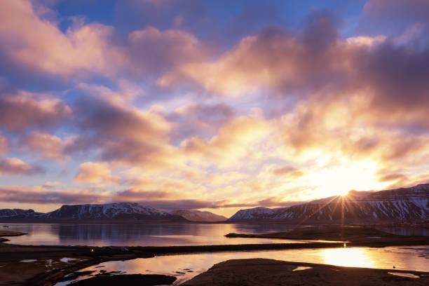 Spring sunrise over the famous Kirkjufellsfoss Waterfall with Kirkjufell mountain in the background in Iceland