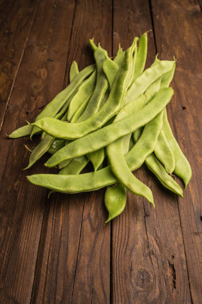 istock A pile of fresh green beans on table. Green runner beans. Top view 825522132