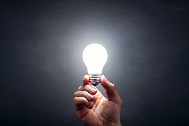 Inspiration - Light Bulb Hand Idea Blackboard stock photo
