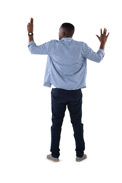 Rear view of man pretending to touch an invisible screen against white background