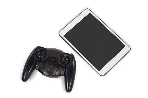 Close-up of joystick and digital tablet on white background