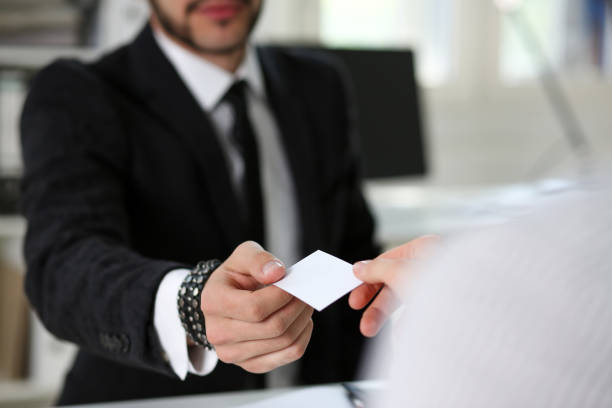 istock Male hand in suit give blank calling card 825531760