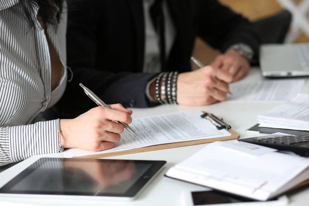 istock Group of people hold silver pen ready to make note 825531784
