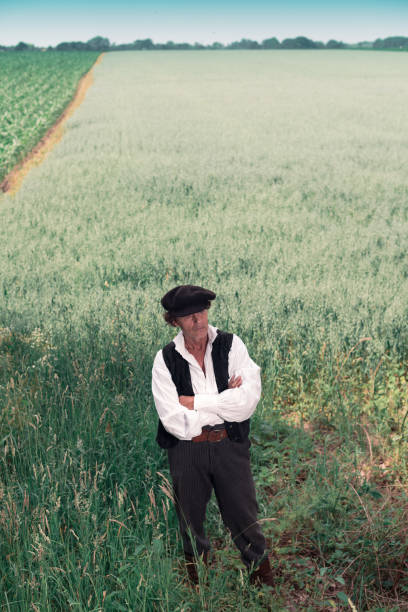 istock Historical man standing in rural field 825537460
